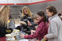 students looking at books