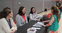 students and teachers at activity station