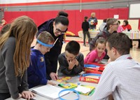 students and adults playing game