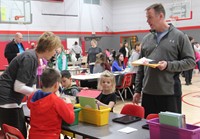 students and adults at activity station