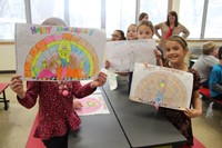 students holding up pictures