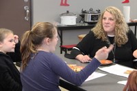 assistant superintendent sitting with students