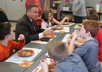 superintendent sitting with students