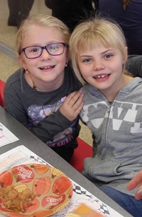 two students smiling at table