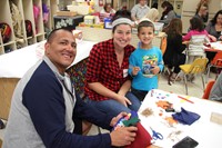 man and woman smile with boy at pre k family day