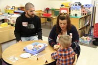 man and woman with boy at pre k family day