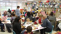 pre k classroom full of families making scarecrow hats