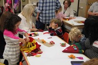 pre k students working hard to create scarecrow hats