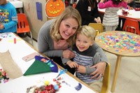 woman and boy smile at pre k family day