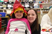 woman and girl who is wearing scarecrow hat smiling