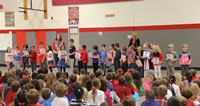 students holding thank you vets signs