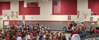 wide shot of veterans and students holding thank you vets signs