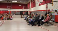 wide shot of gym with students and veterans