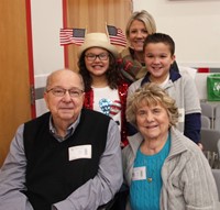 two students with their family with grandpa who is veteran