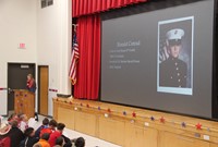 student reading poem during veterans day assembly