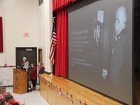 student speaking at veterans day assembly