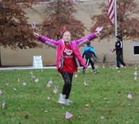 student holding flags in the air