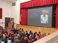 student speaking during veterans day assembly