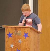 up close of student speaking at veterans day assembly