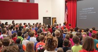 students and staff saying the pledge of allegiance