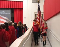 students carrying american flag