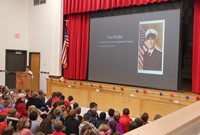 student speaking in front of peers at chenango bridge veterans day assembly