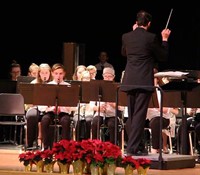 students playing instruments and instructor conducting