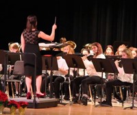 students playing instruments and instructor conducting