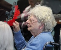 resident holding cardinal ornament