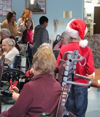 students giving residents ornaments