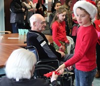 another student handing resident ornament
