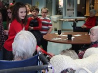 student handing resident ornament