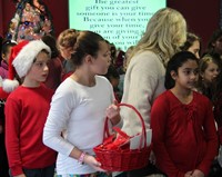 student holding basket of ornaments