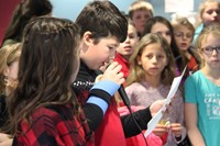 student speaking into microphone