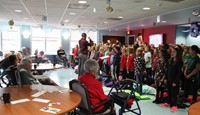 wide shot of students performing for elizabeth church manor residents