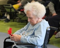 resident looking at cardinal ornament