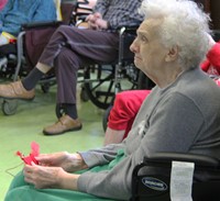 resident holding cardinal ornament