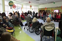 wide shot of students singing for Elizabeth Church Manor residents