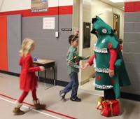 principal dressed as tree saying bye to students