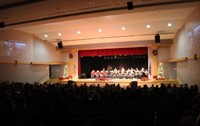 wide shot of band performing armed services salute