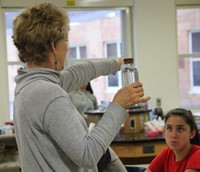 miss ann showing students mindfulness bottle