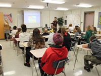 students listening to presentation on veganism