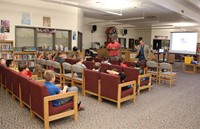 wide shot of presentation with mister clark and mister patterson