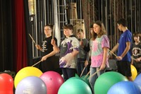 students holding drum sticks