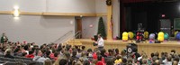 principal attleson speaking with students in auditorium