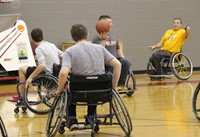 teachers students and instructor taking part in wheelchair basketball