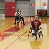 students participating in wheelchair bicycle activity