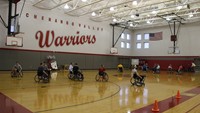 wide shot of students taking part in wheelchair basketball