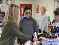 medium shot of students constructing mindfulness bottles