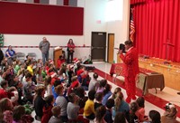 teacher speaking to students at holiday sing along